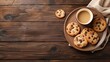 Plate of chocolate chip cookies and a coffee cup on a wooden table