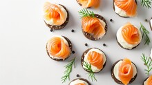 Assortment Of Smoked Salmon And Cheese Appetizers On A White Tableware