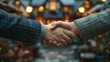 © zai - Close-up of a business handshake in the backdrop of miniature homes