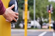 © peopleimages.com - Hand, person and button at pedestrian crossing or traffic light for morning commute, safety or walking. Fingers, pole and sidewalk at intersection or downtown city or street travel, signal or caution
