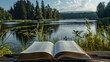 Open book on a wooden table on the background of a forest lake