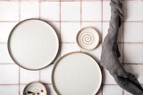 Fototapeta Tulipany - Flat lay textured ripple empty grey ceramic plate with napkin on grey background