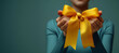 Close-Up of Hands Tying a Bright Yellow Ribbon into a Bow