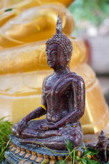 Buddha Statue banyan tree background in Wat Nongtakrong park of Thailand temple , Sonkran festival day in thai.