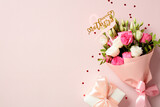 Fototapeta Mapy - Gift box and bouquet of flowers on pink background. Happy Mothers Day concept.