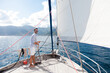 Man sailing on yacht on sea in summer vacation. Traveler enjoying adventure, freedom, wind. Sailor spread the sails. Wanderlust, successful lifestyle on ecological transport in sustainable travel