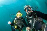 Fototapeta  - Selfie with A beautiful red hair latina scuba diver diving underwater
