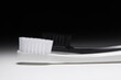 White and black toothbrushes on dramatic background
