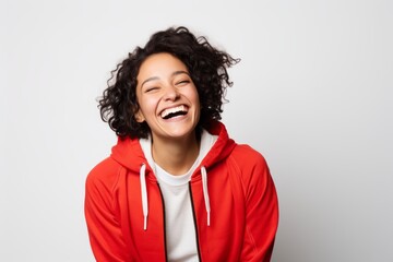 Wall Mural - Portrait of a cheerful woman in her 20s wearing a zip-up fleece hoodie isolated in white background
