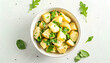 Bowl of tasty Potato Salad with greens on white background