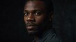 © Arceli - handsome black african man looking at camera serious on dark plain black background from Generative AI