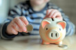 A kid puts a coin into piggy bank, hand close-up. AI generative