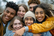 © Fabio - Multi ethnic young people team hugging together outside - International community of students support and help each other