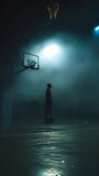Fototapeta Sport - Silhouette of a Basketball Player Preparing for a Game Under Spotlight