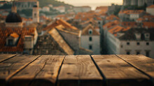 Atmospheric Shot Of A Simple Wooden Table Set Against A Dreamy Blur Of Dubrovnik's Old Town  Merging Past With Present