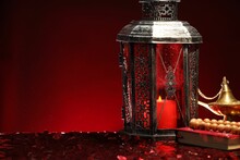 Arabic Lantern, Quran, Misbaha And Aladdin Magic Lamp On Shiny Red Table. Space For Text