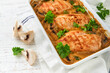 Baked chicken breast bbq with mushrooms and garlic in cream sauce on white wooden table backgrounds. Top view image with ingredients for cooking. Top view with copy space.