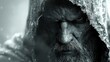   A monochrome image of a bearded man in a hood, snow covering his face