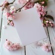 © Fay Melronna  - Blank notepaper with copy space and a spray of pink cherry blossom.