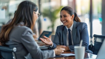 Wall Mural - A diverse business setting with a Hispanic job applicant and a businesswoman expressing satisfaction and agreement.