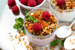 sweet dessert with granola, fresh raspberries and fruit  yoghurt, top view