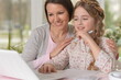 © aletia2011 - Daughter and mom use a laptop at home
