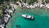 Fototapeta Paryż - Aerial drone top down photo of inflatable speed boat anchored in tropical exotic island