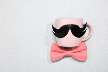 Sticker - Man's face made of artificial mustache, bow tie and glasses on light grey background, top view. Space for text