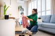 Young woman unpacking her clothes in a rented apartment
