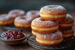 food photography of small, round donuts with sugar and jam on top, placed next to each other in front of an iron grid against the background of dark gray wall.