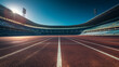 A panoramic view of an empty stadium with a running track, the seats cast in shadow while the track glows under a clear sky. This serene moment captures the calm before the storm o