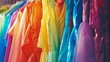 Fashion clothes on clothing rack bright colorful closet closeup of rainbow color choice of trendy female wear on hangers