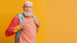 © Alina Zavhorodnii - Old grey-haired man doing sports on yellow background with space for your text