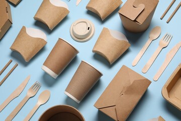 Wall Mural - Eco friendly food packaging. Paper containers and tableware on light blue background, above view