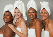 Beautiful multiracial women smiling on camera during spa day - Multi generational people doing skin care treatment together