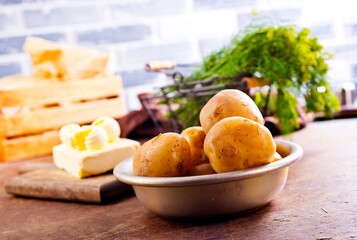 Poster - Fresh raw baby potato in bowl on wooden background.