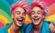 Portrait of two laughing queer men with pink hair and piercing celebrating Pride month against a colorful vibrant rainbow background. Smiling LGBTIQA+ community people with LGBT flag on shoulders