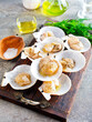 From above fresh appetizing scallop with shell served on wooden boars