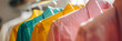 © john - bright colored shirts on wire hangers, hanging on a rack, bright and airy