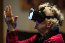 Senior Lady Using VR Technology For Interaction