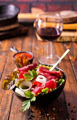 Poster - salad with jamon and red wine on wooden table