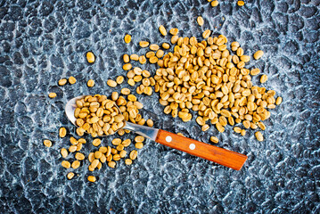 Poster - Green coffee beans on black table