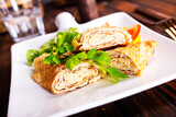 Fototapeta Tulipany - Dashimaki tamago, Japanese style rolled omelette in dish on wooden table