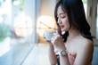 Portrait of beautiful happy Smiling asian woman relaxing sitting in cafe interior in coffee shop background,Business Lifestyle summer holiday concept