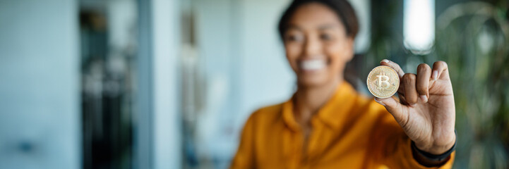 Poster - Happy businesswoman showing bitcoin, working in office