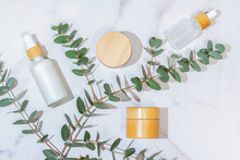 Natural Skincare Products With Eucalyptus On Marble
