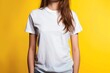 young woman modeling white tshirt mockup against vibrant yellow background clothing design template