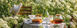 Elegant glamour table setting outdoor in the garden. White porcelain cups, teapot with herbal tea, homemade cherry sweet pie. Family tradition, beautiful place outside. Flower meadow, candles. Banner