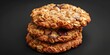 A stack of oatmeal cookies on a wooden table, ideal for food bloggers or recipe websites