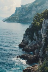 Poster - A person standing on the edge of a cliff overlooking the ocean. Perfect for travel and adventure concepts